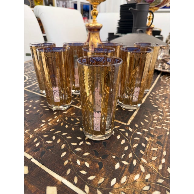 Set of 8 1950s highball cocktail glasses. Designed with gold motif and lavender rims making them very attractive and...