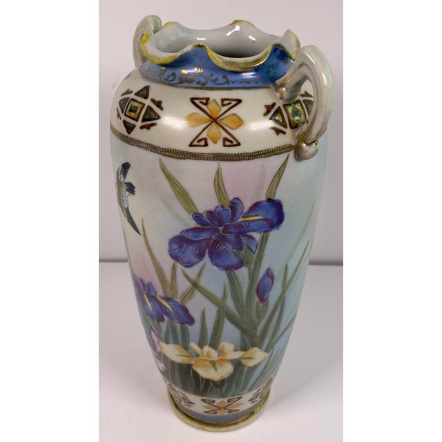 A beautifully detailed antique Japanese porcelain vase featuring an elegant hand-painted scene of colorful iris flowers...
