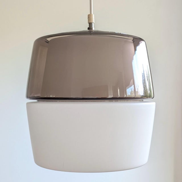 Great modernist pendant light by the German company Peill & Putzler. The light consists of two separate glass parts that...