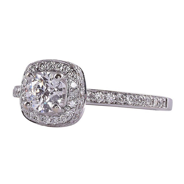 Estate 18K white gold diamond engagement ring. This estate engagement ring features a hearts and arrows cut center diamond...