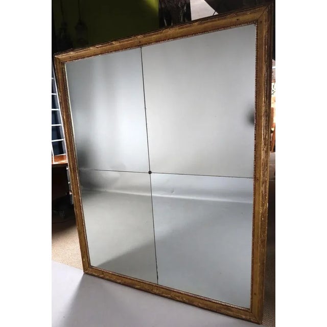Large mirror in gilded wood from the end of the 18th century at the beginning of the 19th century composed of four...