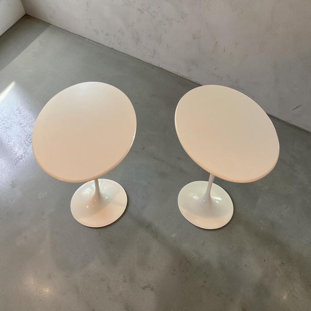A sophisticated pair of authentic Knoll International oval Tulip side tables designed by Eero Saarinen. Featuring the...