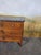 A louis xvi style cherrywood commode with inlaid stringing. an elegant louis xvi style commode with three drawers on the...