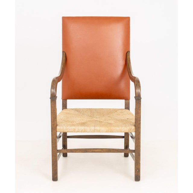 Fritz Hansen Style Walnut Armchair, with burnt orange leather riveted upholstered back with woven seat and burnt orange...