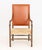 Fritz Hansen Style Walnut Armchair, with burnt orange leather riveted upholstered back with woven seat and burnt orange...