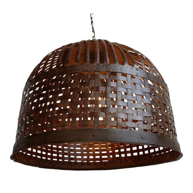 Vintage Indian iron cage basket thoughtfully repurposed into a one-of-a-kind pendant light, celebrating the raw beauty of...