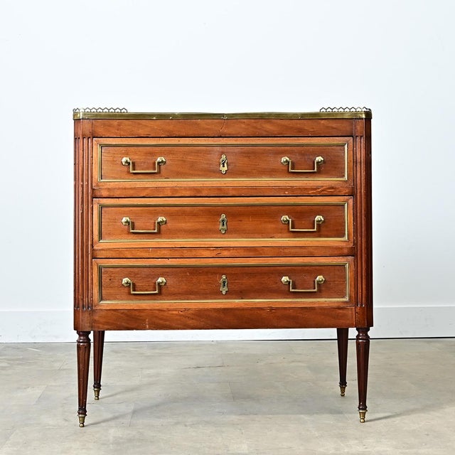 A gorgeous Louis XVI-style petite commode with inset marble top. The Sainte Anne marble has stunning grey and white...