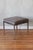 The sleek, geometric design of this stool exemplifies the precise, rational approach to craftsmanship that Mies van der...