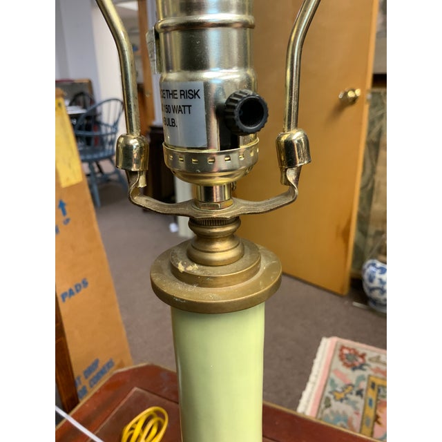 Mid Century Modern ceramic light avocado green lamp on brass base. Great color and more of a matte finish that a shine to...