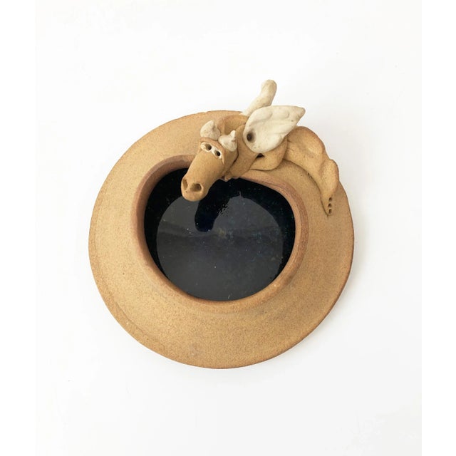 A vintage studio pottery tray. Nice natural stoneware exterior with a quirky dragon formed on the side. Beautiful dark...