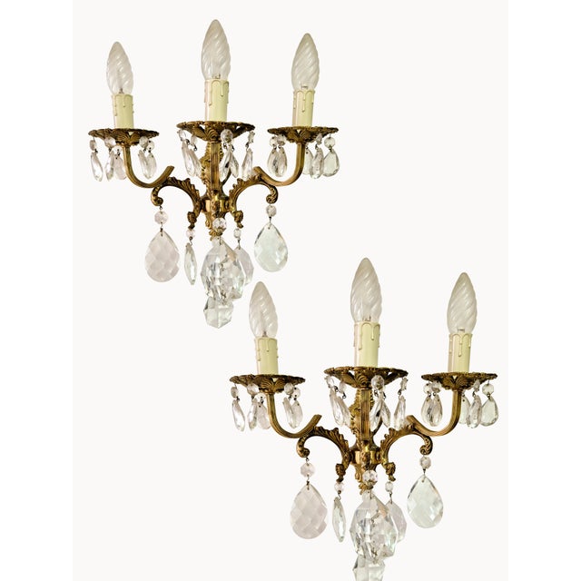 A refined pair of wall lamps in the authentic King Umberto of Savoy style, crafted from finely chiseled bronze and...