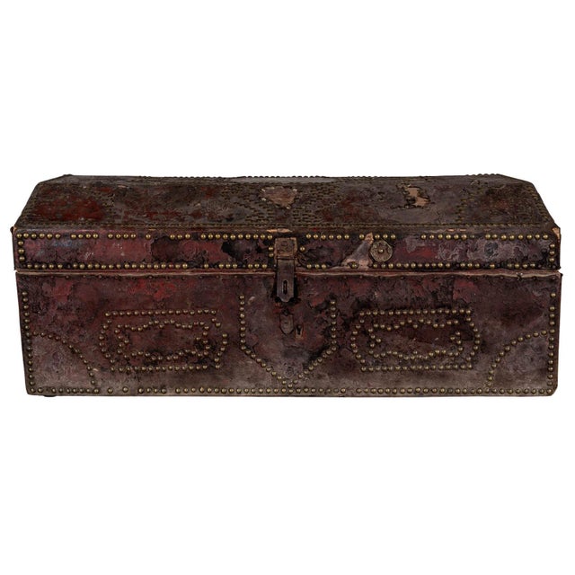Leather chest with original hardware. Intricate studded details. Iron front clasp and side handles.