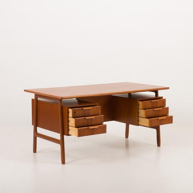 This spacious desk, "Model 75," designed by Omann Jun in the 1950s, exemplifies mid-century Danish craftsmanship. The desk...