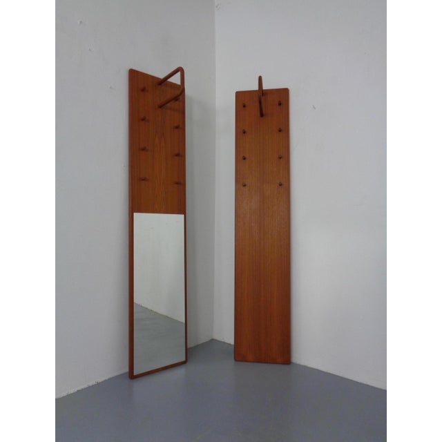 Two teak coat racks by Kai Kristiansen for Vildbjerg Møbelfabrik, dating from the 1960s. One of the coat racks includes a...