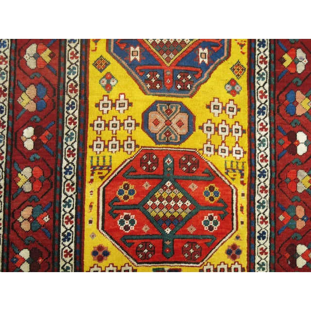 An early 20th century Caucasian Karabagh runner featuring a bright yellow ground. Measures: 3'3" x 10'11" Karabagh rugs...