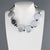 Handcrafted in Italy, this beautiful Angela Caputi resin necklace features a pearlized silver tone with black contrast....