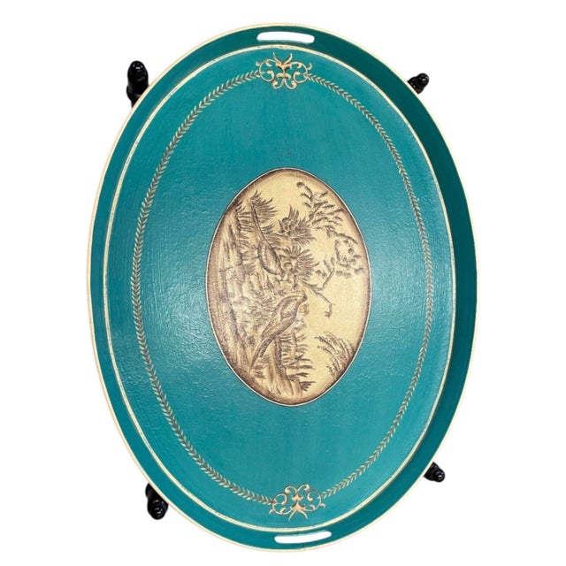 This striking vintage accent piece features a removable oval metal tray paired with a sleek, collapsible black metal...
