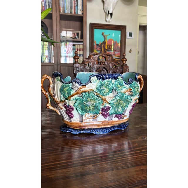 Beautiful vintage majolica-style planter featuring raised grape clusters, textured vine details, and rich cobalt blue...