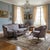 A beautiful 1920s French‑style sofa and matching chair, featuring an ornate carved wood frame and richly patterned...