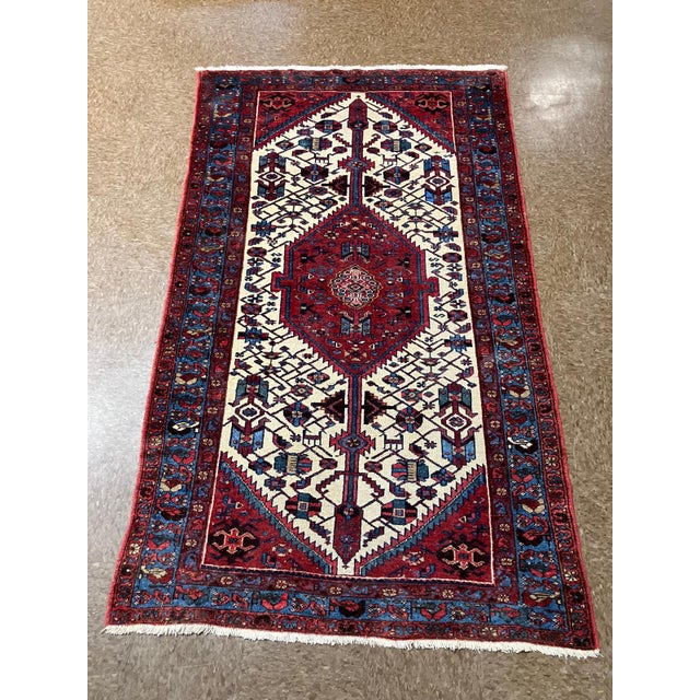Hand-knotted Persian Zanjan rug with a central red medallion set on an ivory field, featuring a stylized Tree of Life...