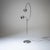 Chrome-plated floor lamp with a circular base and slender stems with adjustable necks and two round shades. The lights can...