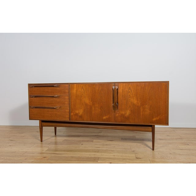 A small sideboard manufactured in the 1960s by the British manufacturer McIntosh. The sideboard has three drawers on the...