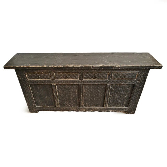 Hand carved old solid wood sideboard with rich black finish. Features four top drawers and four doors below opening to...