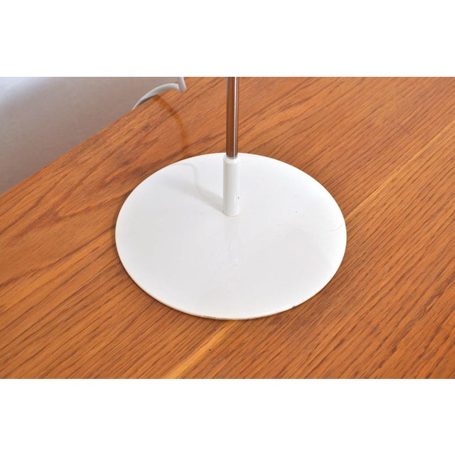 Stylish metal desk lamp from the 1960s with on/off switch on the back of the shade. The hood can be adjusted using a knee...