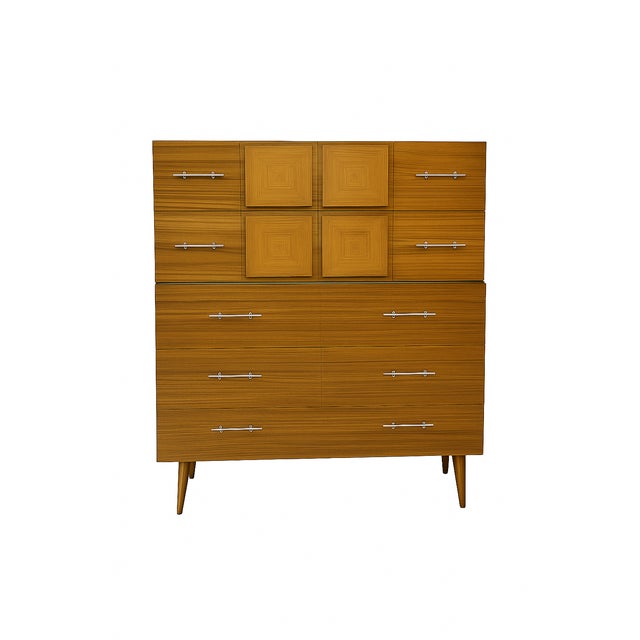 Stunning matched pair of mid-century modern dressers. These large sculptural case pieces feature clean vertical lines,...
