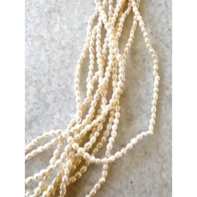 Gorgeous vintage multi strand freshwater pearl necklace. Gold tone metal clasp. 28” long