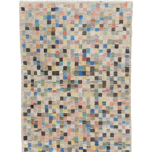 This mid-20th-century Turkish Anatolian throw rug presents a lively mosaic-like composition built from hundreds of small...
