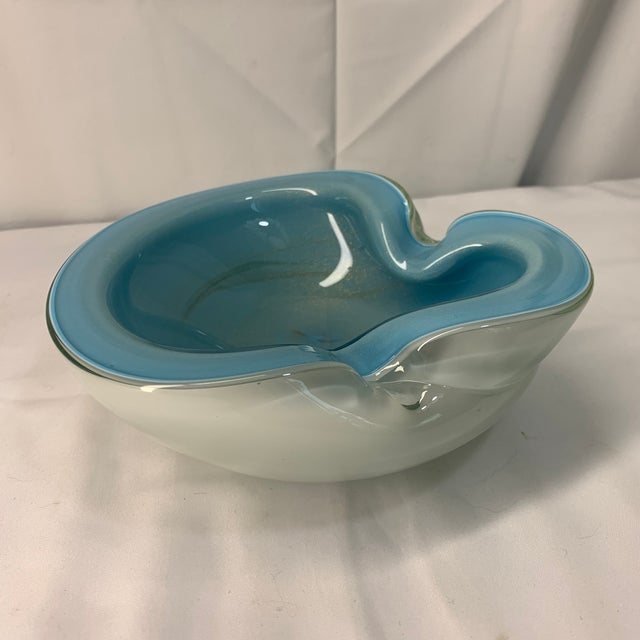 Elevate your tablescape or vanity with this captivating 1960s Murano art glass catchall bowl, expertly handcrafted in...