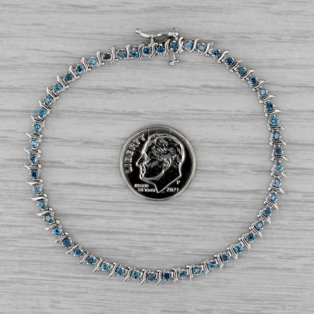Gemstone Information: - Natural Diamonds - Total Carats - 1.10ctw Cut - Round Brilliant Color - Treated Blue Clarity - I2...