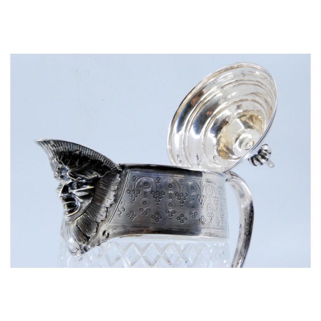 Silver Wine Jug with Faceted Glass, Lid, Handle and Engraved Surround with Bacchus Head, in Very Good conditions. Designed...