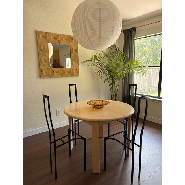 Set of 4 Postmodern Italian dining chairs designed by Maurizio Cattelan in the 1980s with a sculptural metal backrest. The...