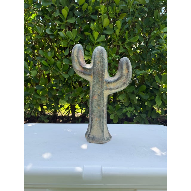 A striking vintage ceramic cactus sculpture featuring a softly modeled, sculptural silhouette and richly textured desert-...