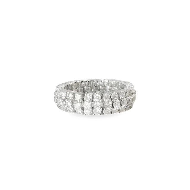 This diamond eternity wedding band is crafted in 18K white gold and features numerous brilliant round diamonds, totaling...