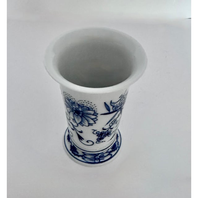 Vintage Meissen Blue Onion vase in trumpet shape, with blue decoration on white porcelain. Base of vase measures 2.3”...
