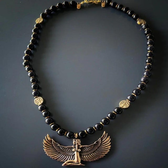 The Magical Goddess Isis Pendant Black Beaded Necklace is simple yet elegant. This handmade necklace combines gold...