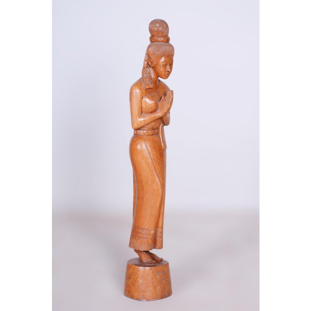 This elegant sculpture dates back to the mid-20th century and is an example of traditional Asian wood carving that carries...