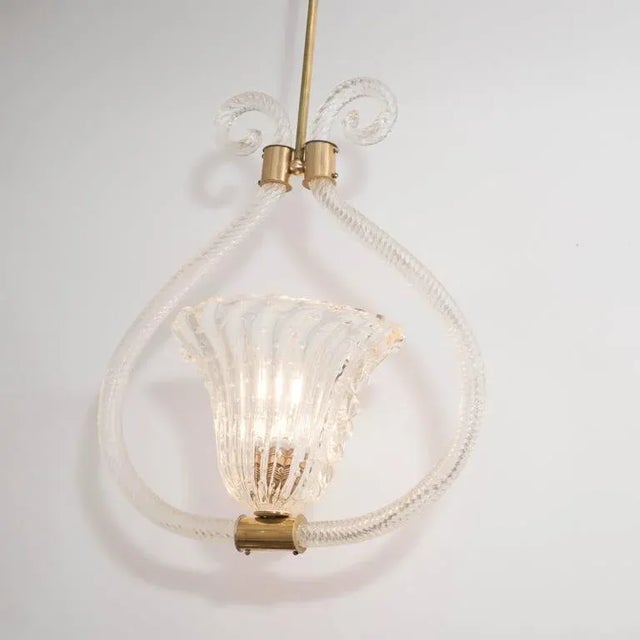 A Barovier e Toso pendant in handblown 'Bullicante' Murano glass and polished brass. A ribbed and controlled-bubble glass...