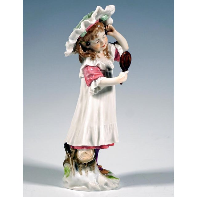 Excellent art nouveau porcelain figurine by paul helmig: a standing girl wearing a wide-brimmed white hat with a mint-...