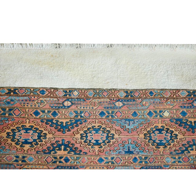 An interesting early 20th century Persian Soumak rug with bold stripes woven with stylized floral patterns, and flanked...