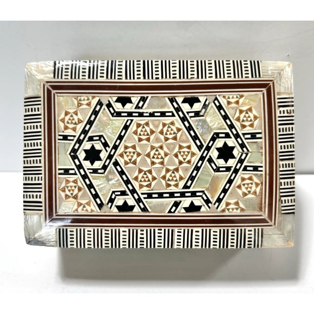 A finely handcrafted Anglo-Indian mosaic box featuring intricate Moorish geometric inlay in mother of pearl, stone, and...