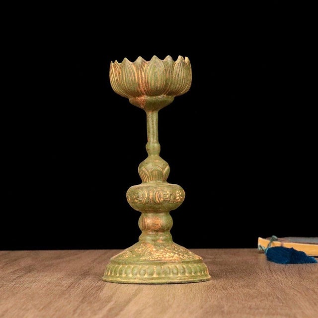 This elegant bronze candlestick features a classic lotus design, a traditional symbol of purity and enlightenment. The...