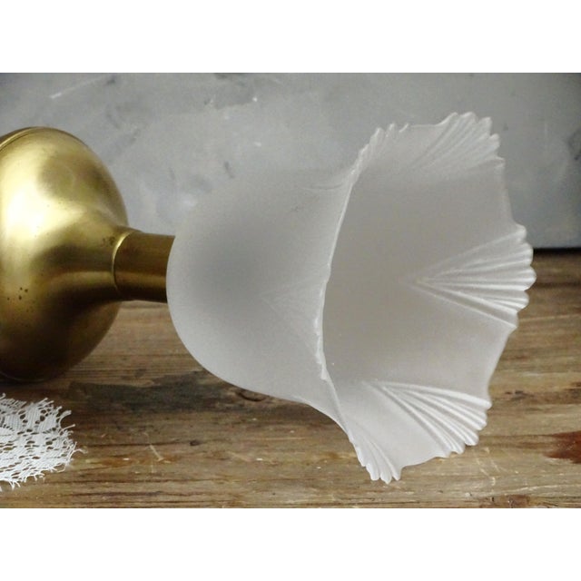 Romantic table lamp with milky white glass shade with somehow pointed floral / tulip pattern and large solid brass base,...