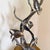 Graceful ocean-inspired metal sculpture with sea turtle, tropical fish, and flowing reef forms in a dramatic vertical...