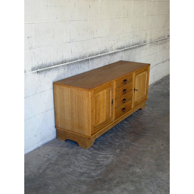 This low sideboard offers practical storage through a beautifully symmetrical layout. The long facade features four center...