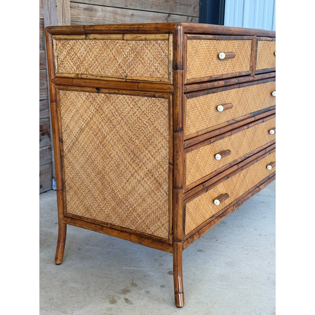 Beautiful vintage five-drawer chest by E. Murio Manila featuring a warm tortoiseshell-toned rattan frame with woven raffia...
