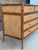 Beautiful vintage five-drawer chest by E. Murio Manila featuring a warm tortoiseshell-toned rattan frame with woven raffia...